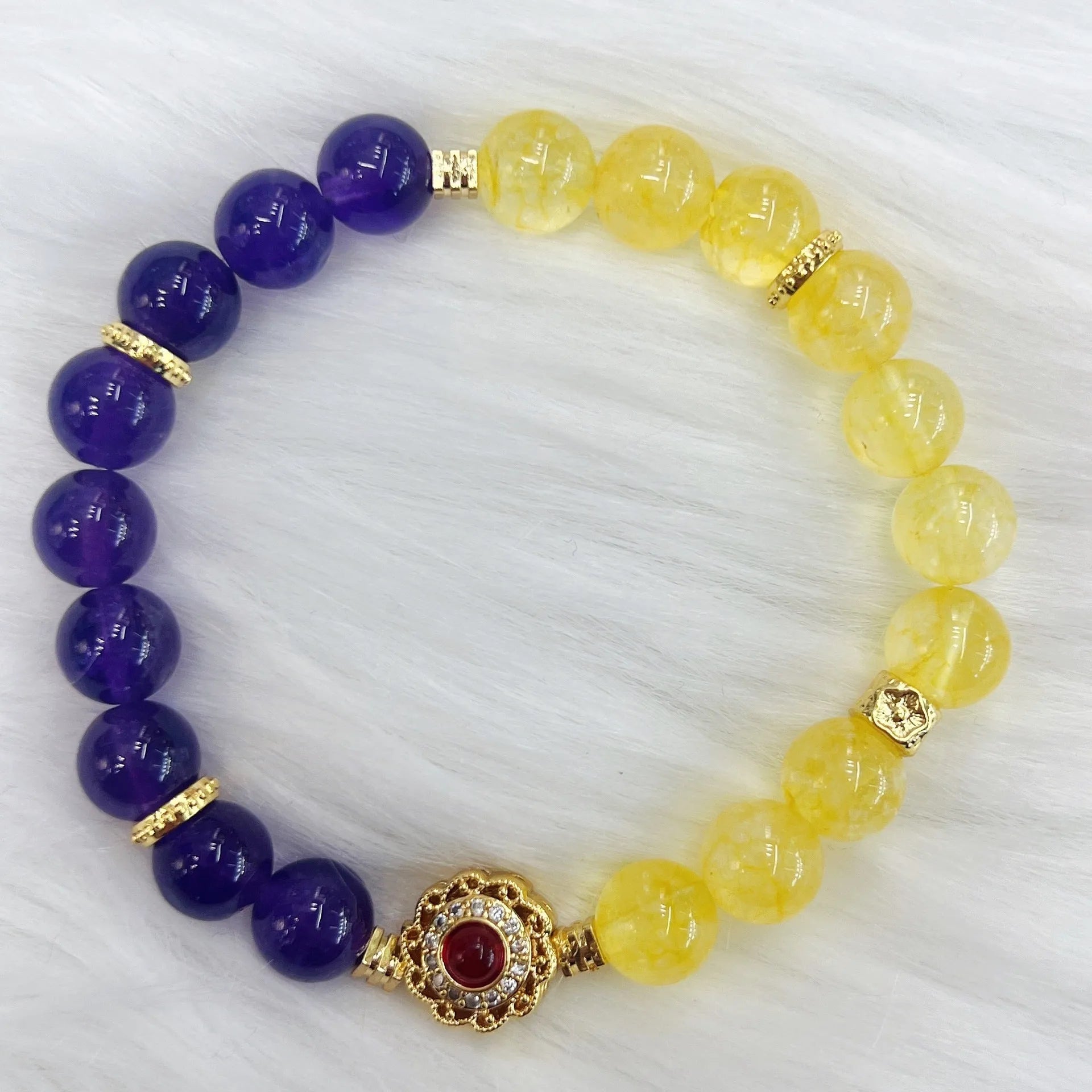 Handmade women's yellow and purple amethyst crystal bracelet showing manual craftsmanship detail