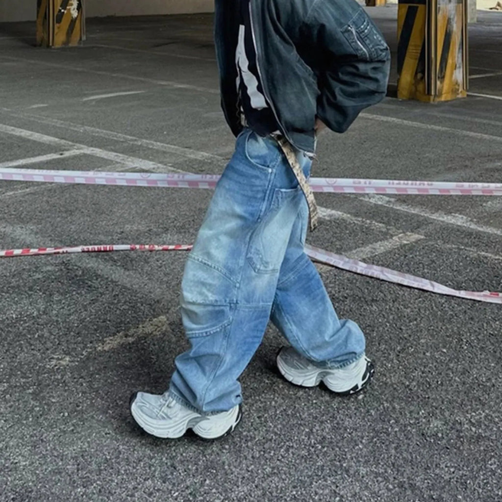Men's straight leg baggy jeans in a washed blue denim colour with a zip fly.