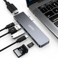 Silver aluminium alloy USB-C multi-port hub with SD card slot, HDMI, and USB ports.