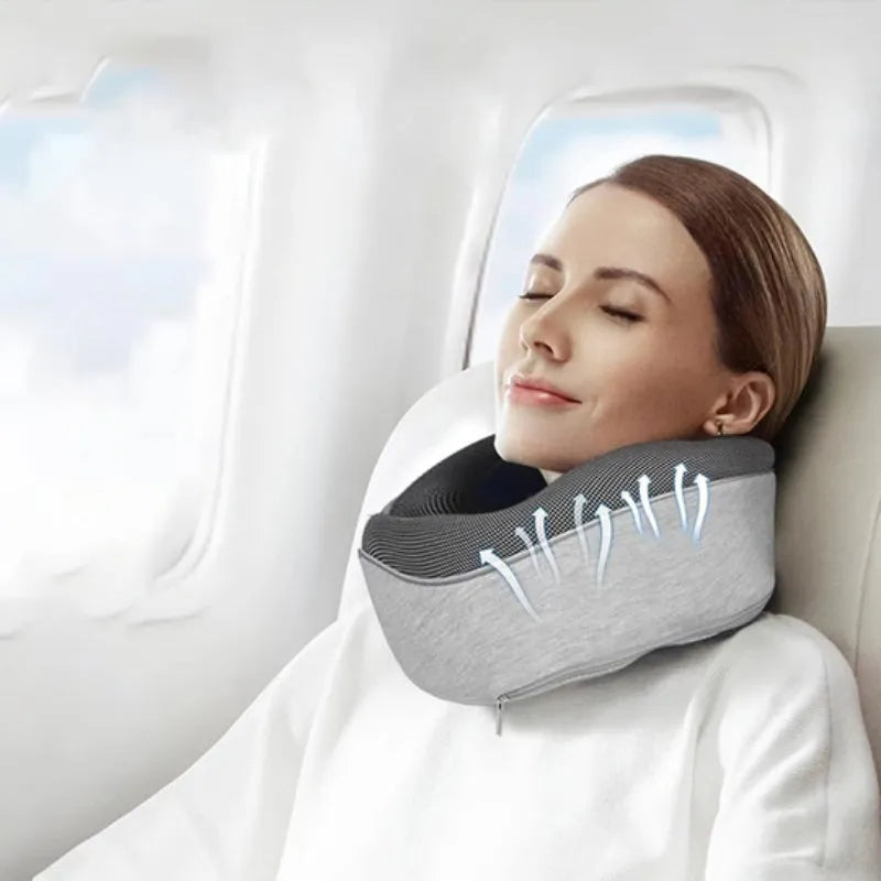 Navy blue U-shaped travel neck pillow with memory foam filling shown rolled for compact storage