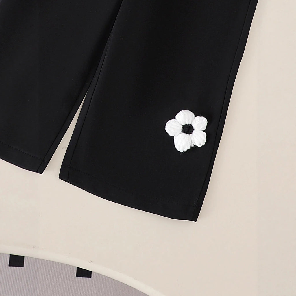 White floral long sleeve top and black trousers baby outfit set in cotton, sizes 6-9M to 2-3Y