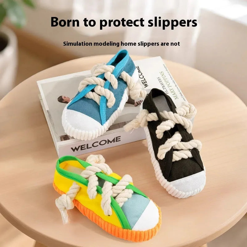 Plastic dog chew toy in slipper shape with sound feature, shown in yellow, black, and blue colour options.