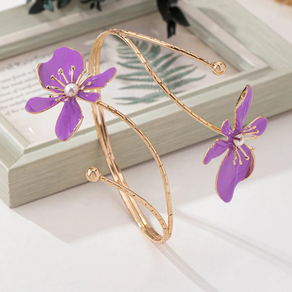 Pink alloy armband with hollow line pattern, shown as an open cuff bangle.