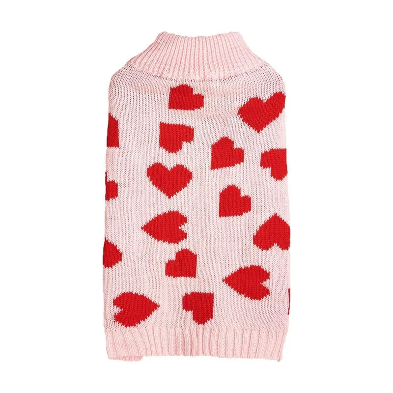 Red dog sweater with white love heart and bow design on a small dog