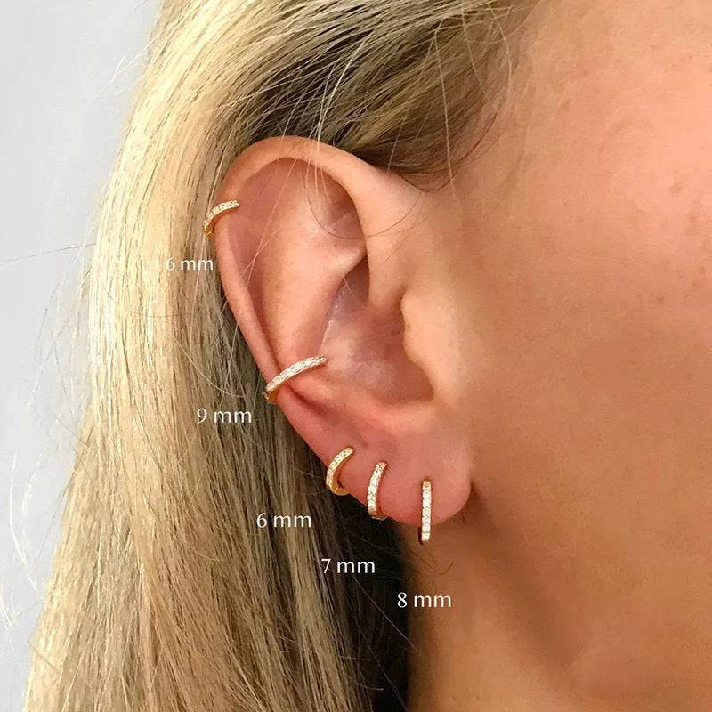 Circle zircon perforated stud earrings in gold, rose gold, and silver colour on a card.