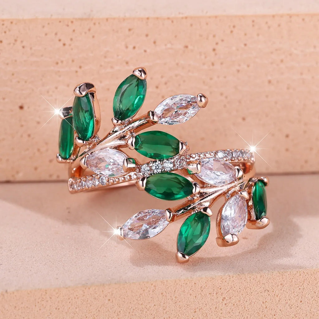 Adjustable copper leaf-shaped ring with a Horse Eye Zircon stone, shown in a rose gold finish.