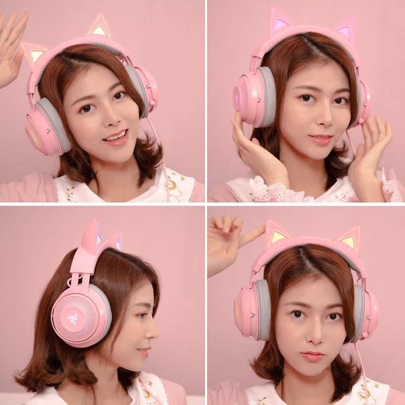 Pink glowing cat earphones with wired USB connection and head-mounted design on a desk