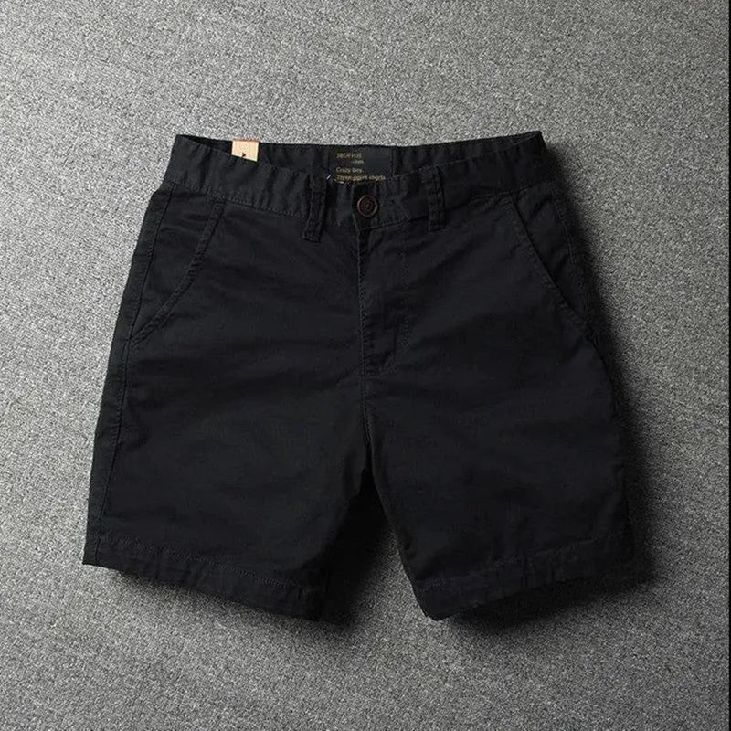 Men's loose fit cotton shorts in a straight-leg style with a zipper fly, shown in a camouflage print colour.