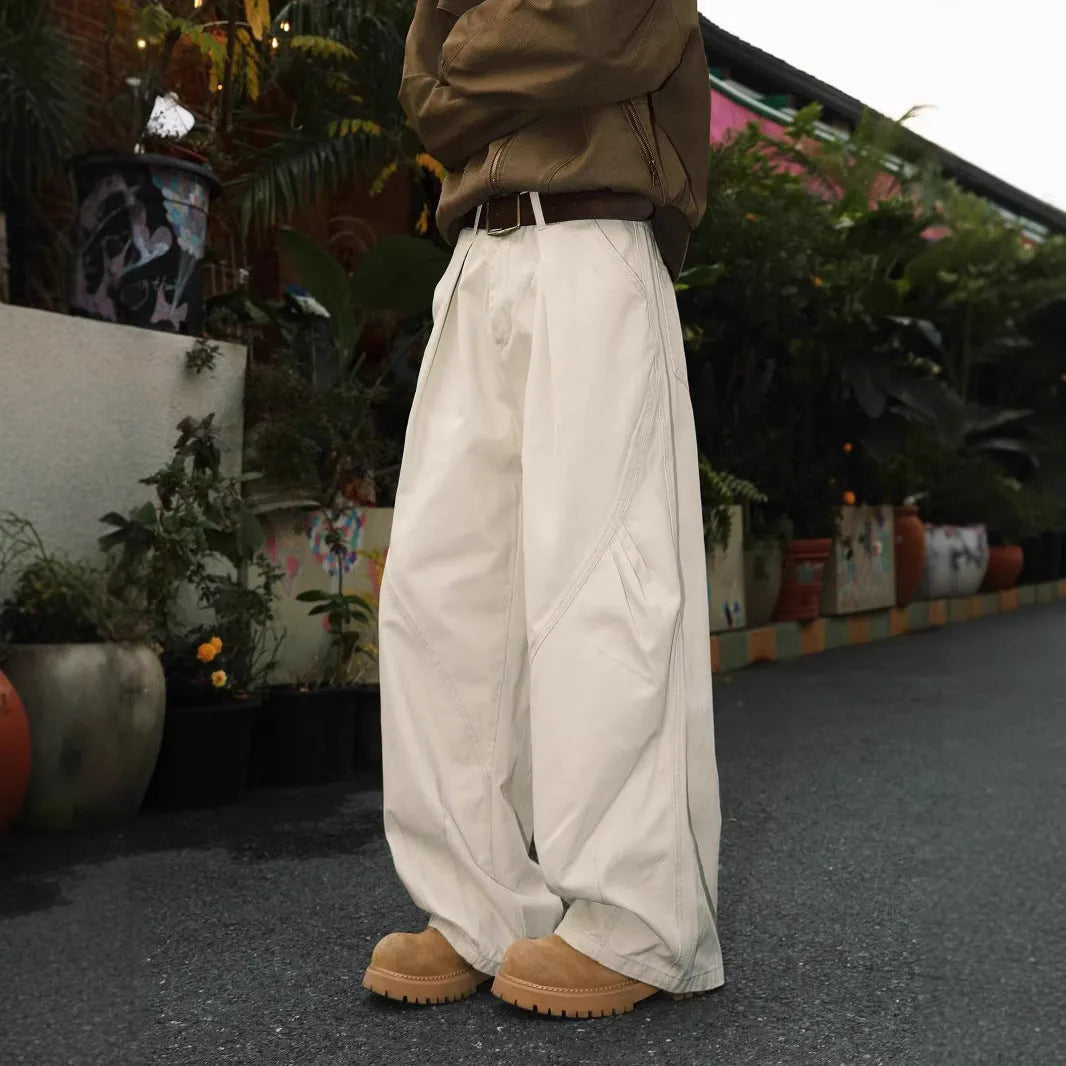 Men's pleated straight-leg trousers in a striped pattern, showing loose fit and straight hem.