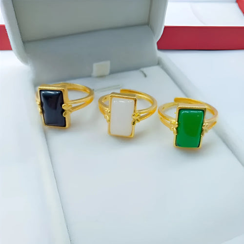 A gold-coloured adjustable ring with a large central green artificial gemstone, showing the national style design.
