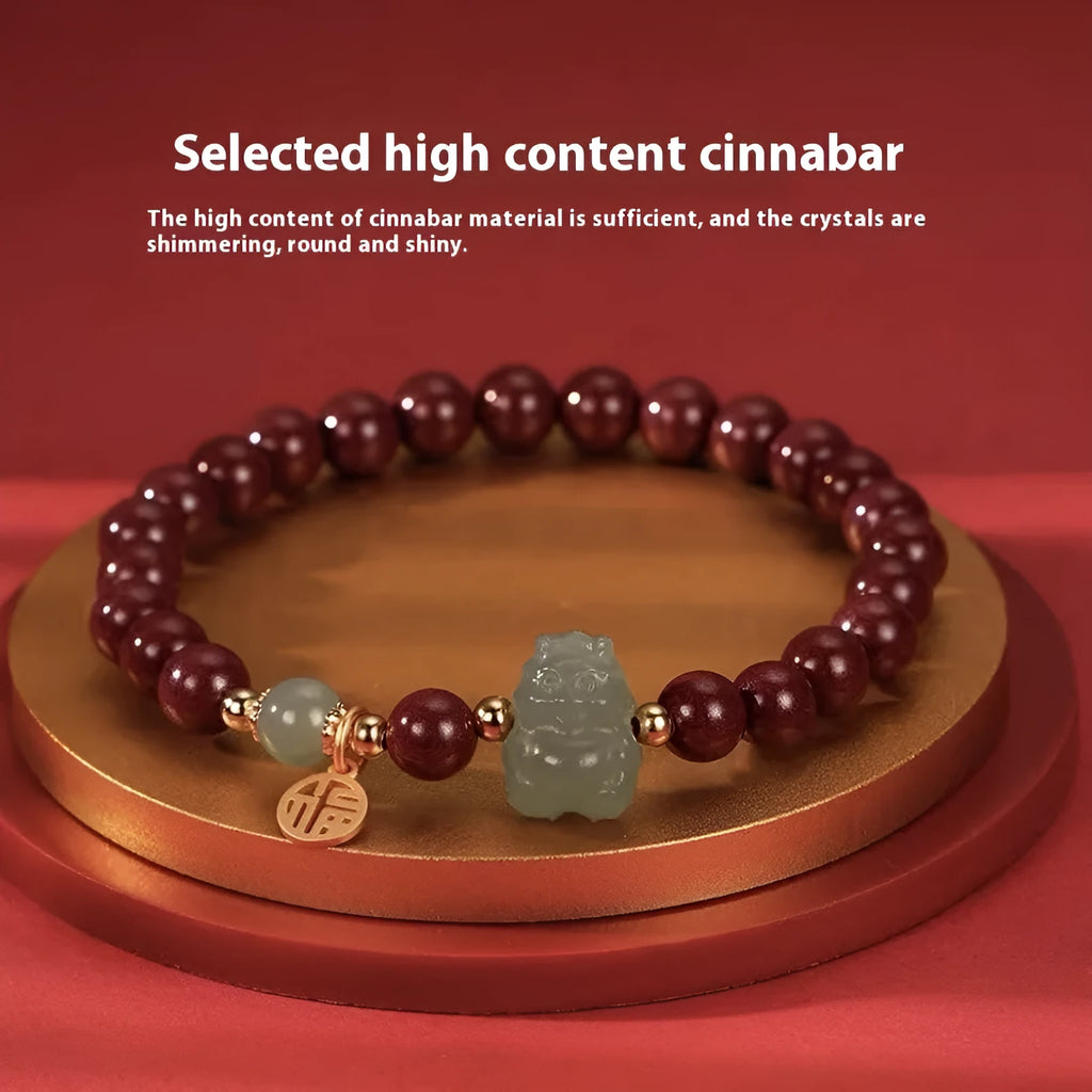 Natural Hetian Jade bracelet with cinnabar detail and zodiac charm on wrist.