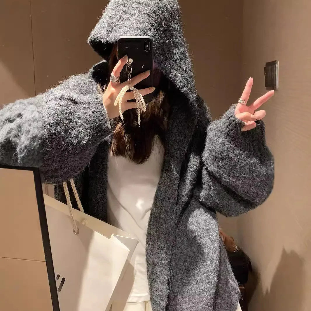 Woman wearing a dark grey retro knit Maillard pattern hooded cardigan