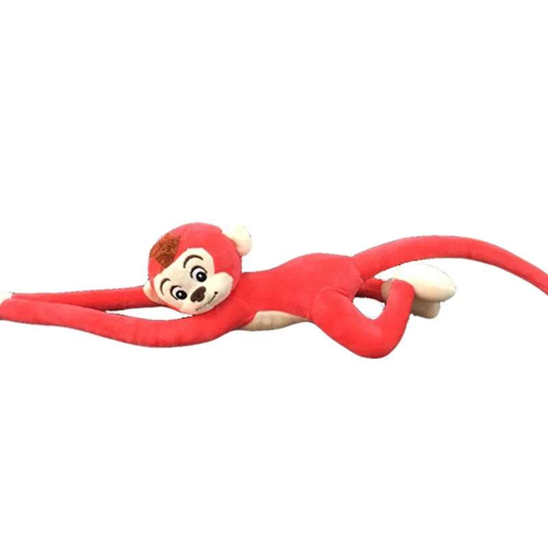 Long-armed pink plush monkey toy hanging from a curtain rod