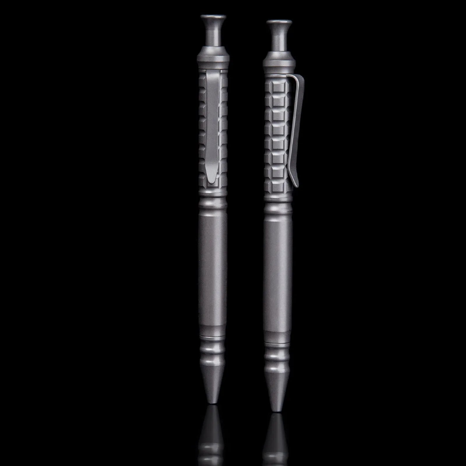 Gunmetal grey titanium tactical pen with push-action decompression mechanism