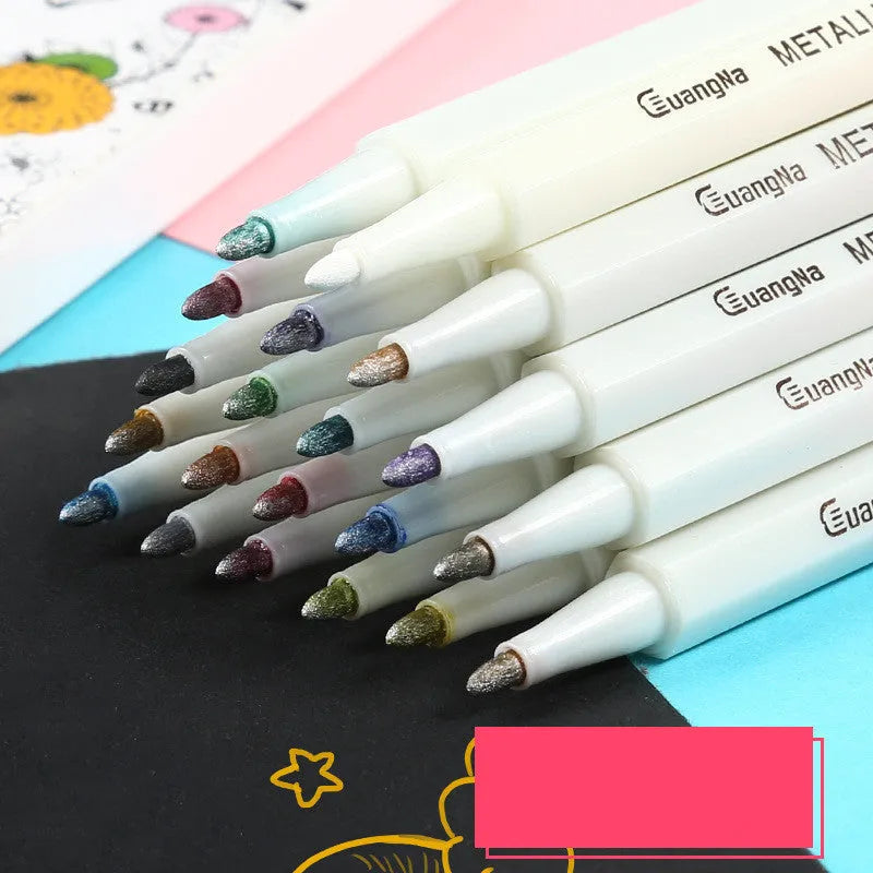 Black plastic album case open to show a set of assorted colour metal pens for office stationery.