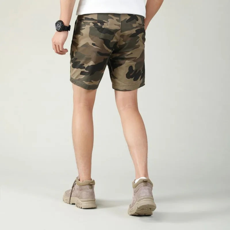 Green camouflage cotton shorts with zip fly on a mannequin, showing mid-waist fit and shorts length for casual wear.