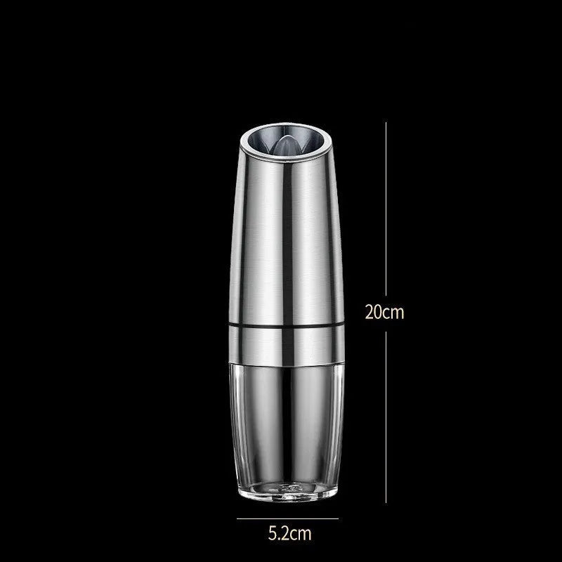 Black and white electric salt and pepper grinder set with USB charging cable on a kitchen worktop.