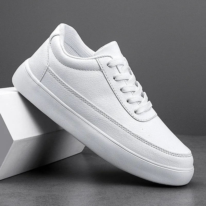 Women's white leather lace-up flat casual shoes shown from the side.