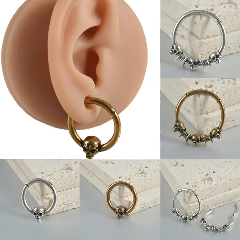 Close-up of copper punk earrings with a detailed ghost head design in antique silver finish.