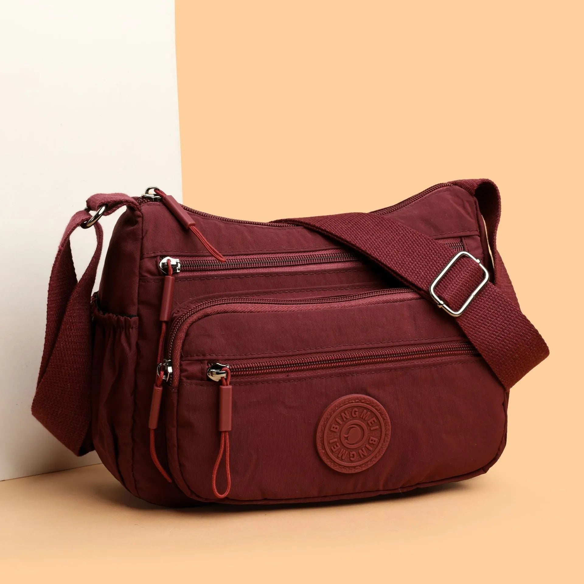 Water-repellent nylon crossbody bag with three-dimensional pocket in black, grey or red