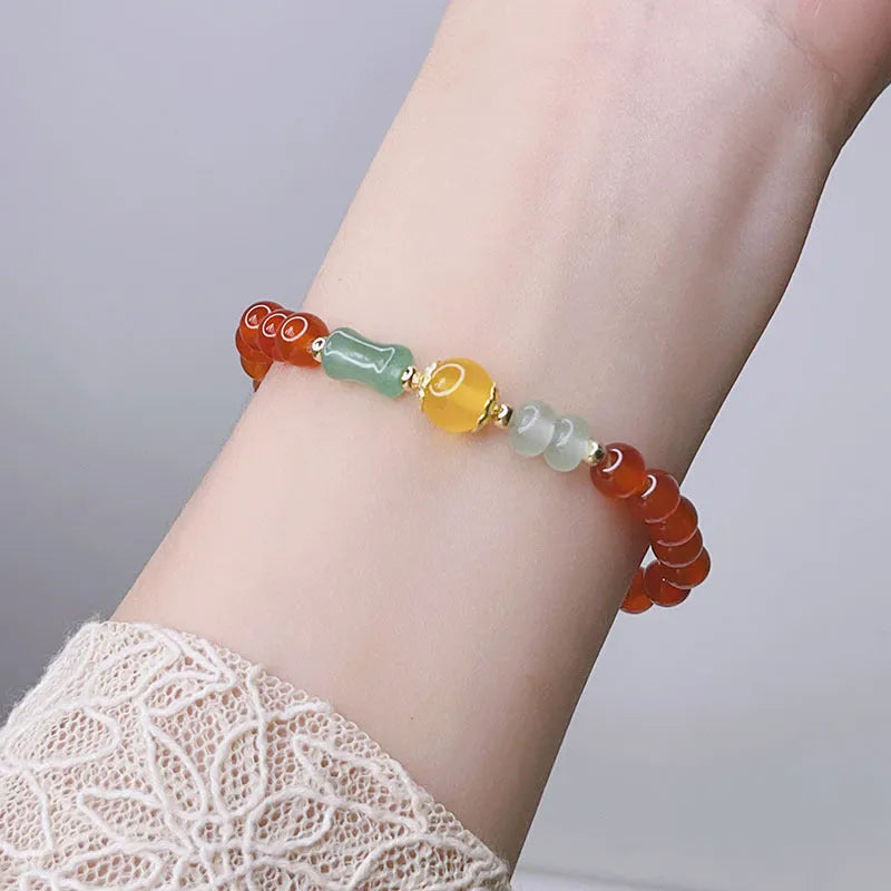 Close-up of a handmade red agate bracelet for women with a traditional Chinese dragon design.