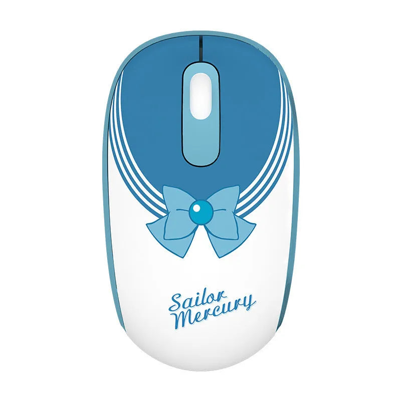 Pink Sailor Moon cartoon character wireless mouse on a desk next to a laptop.