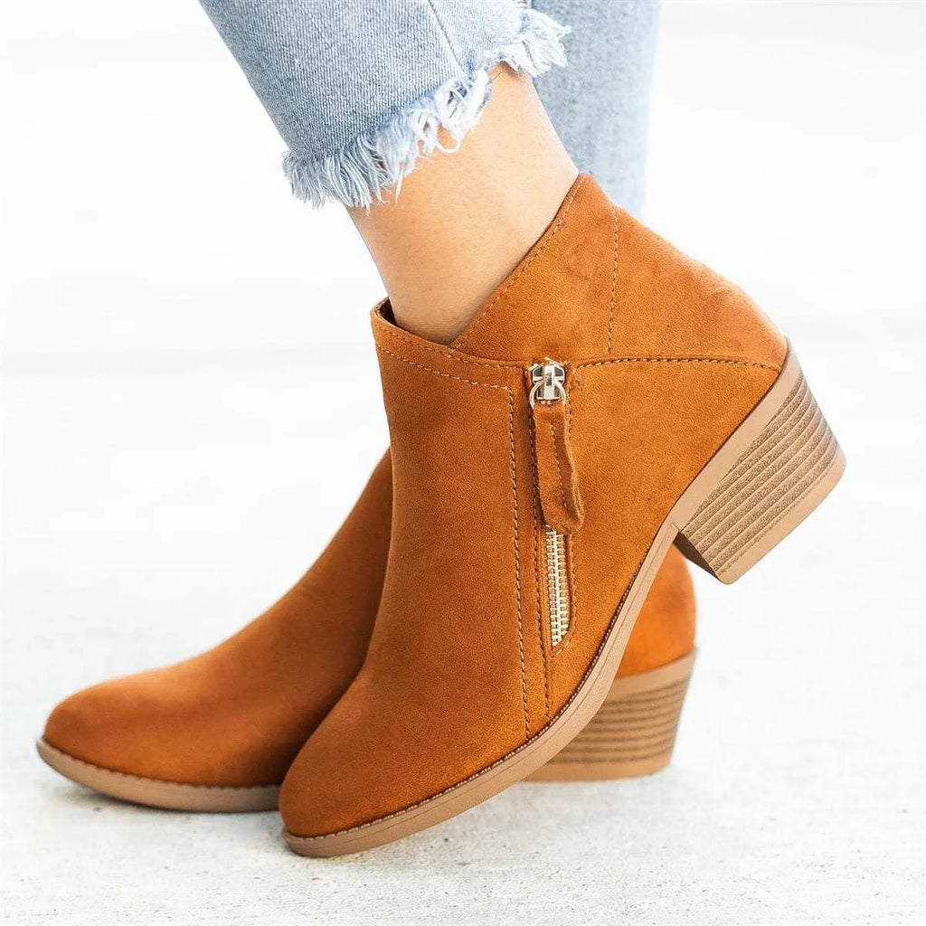 Women's suede ankle boots with a chunky heel and side zip, shown in beige, black, blue, and orange colour options.