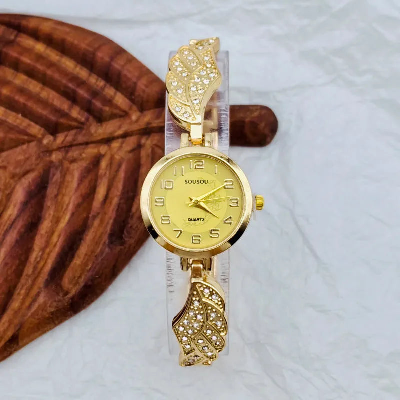 Stainless steel women's watch with round dial and Vachette clasp in gold, black and gold, or gold and white.