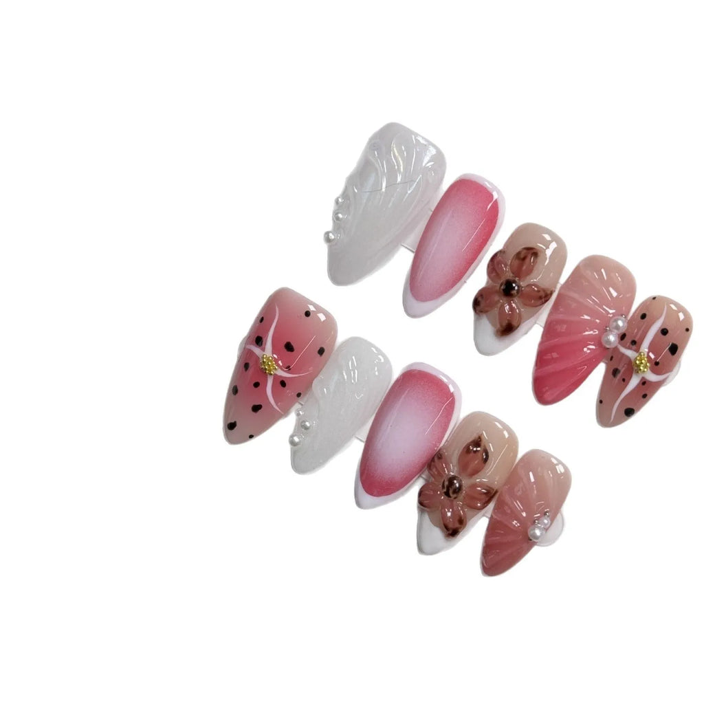 Close-up of hand-painted 3D carved nail art patches with colourful embossed candy patterns.
