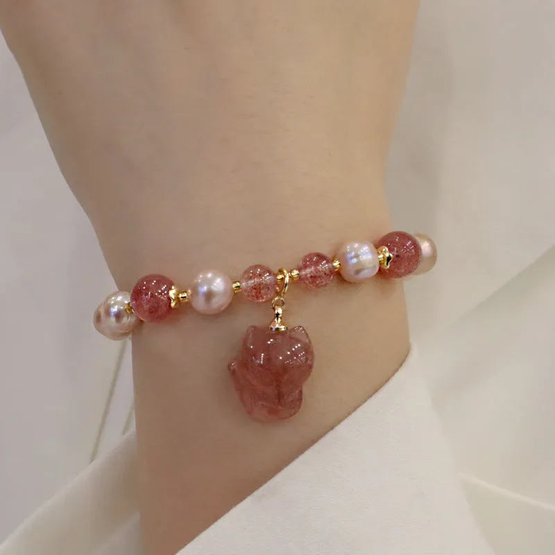 Women's light pink freshwater pearl bracelet with fox charm and strawberry quartz stones