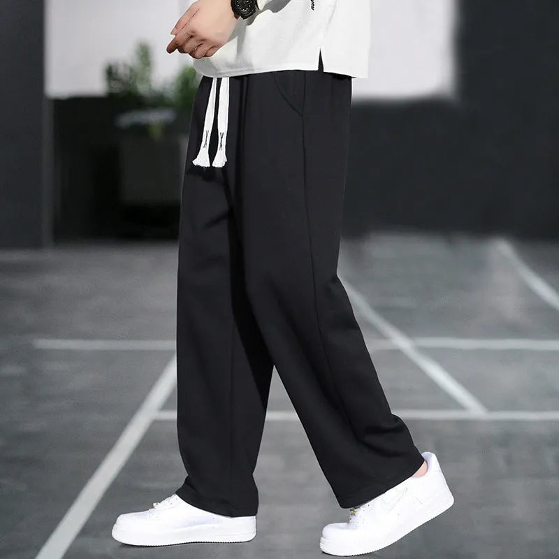 Men's grey casual trousers with multiple pockets showing high waist design and full length
