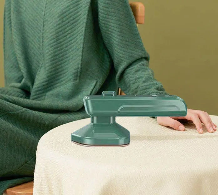 Dark green portable hanging ironing machine with ceramic panel and handheld design.