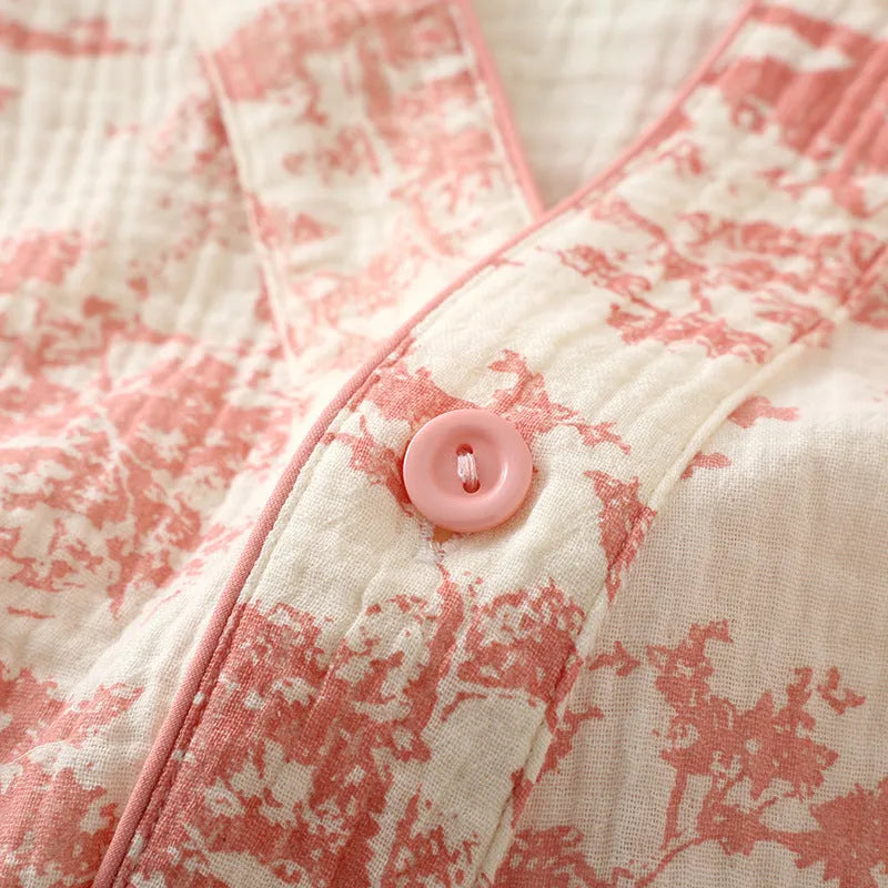 Women's pink cotton gauze lounge suit set with long sleeves and trousers laid flat.