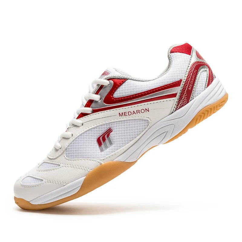 Mesh table tennis sneaker in white and red colour with lace-up front and rubber sole.