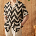 Beach knitted short-sleeved cardigan in black with lapel collar and loose fit on a woman