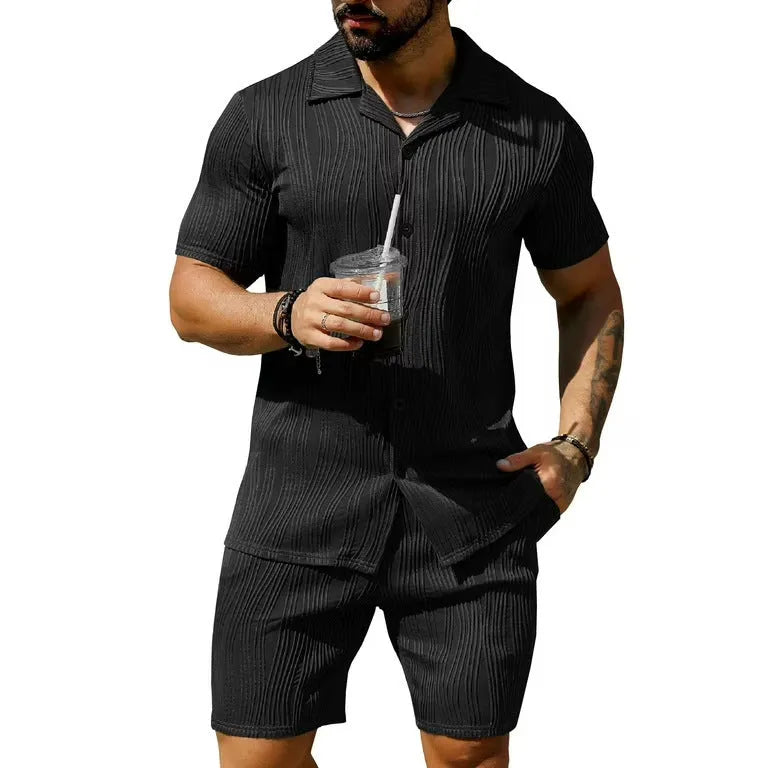 Men's black wave pattern short sleeve top and matching shorts casual set on a hanger.