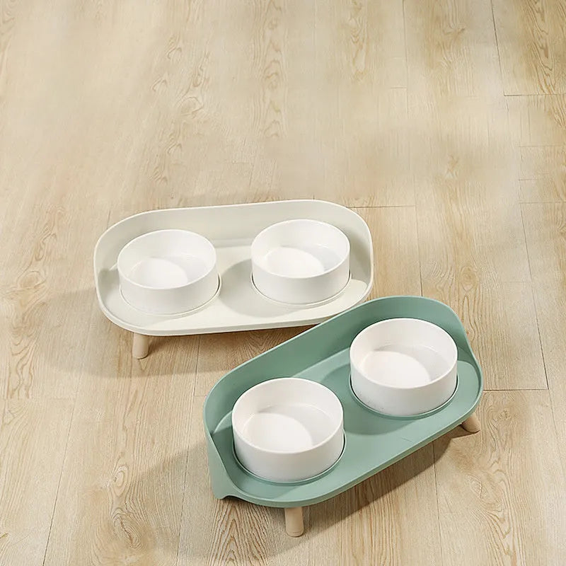 Green adjustable tilted pet feeder with two bowls for cats and dogs