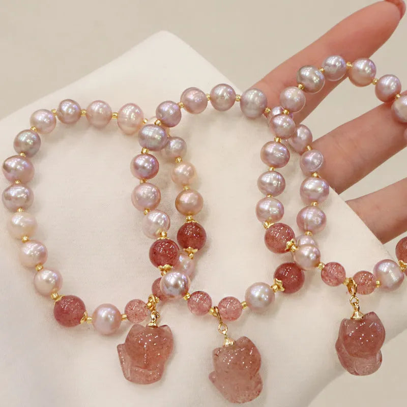 Women's light pink freshwater pearl bracelet with fox charm and strawberry quartz stones