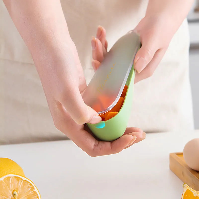 Green plastic handled vegetable peeler stored inside its own clear plastic tube.