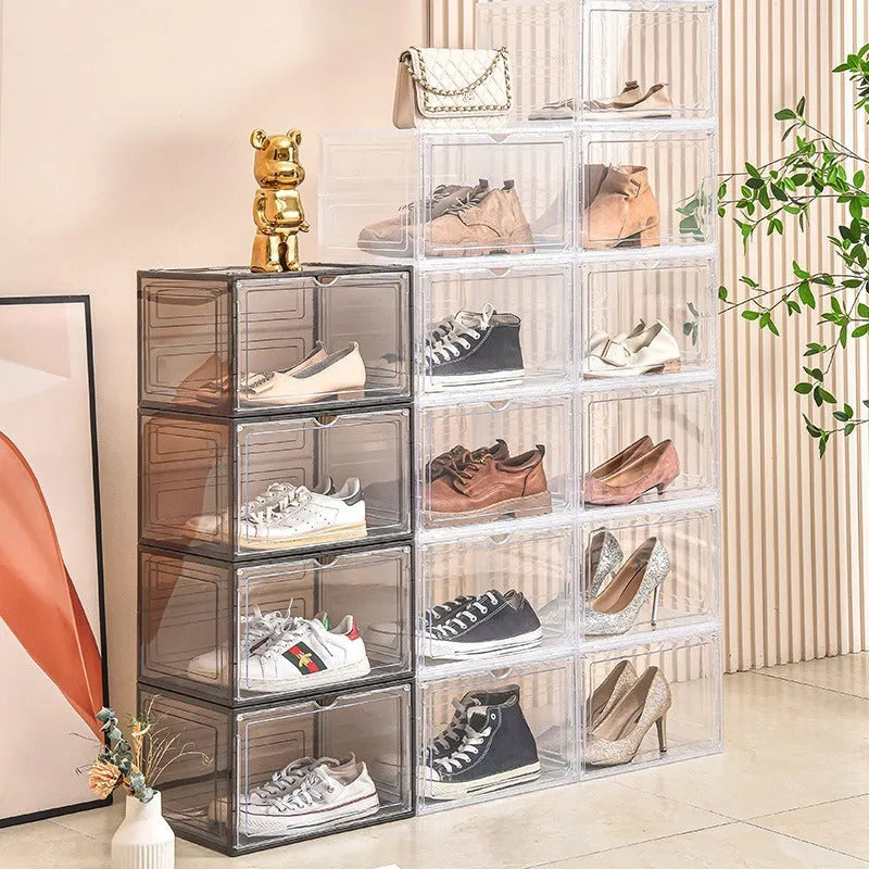 Large clear acrylic shoe storage box with a magnetic side door open, showing shoes inside.