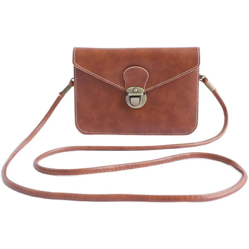 Retro soft surface crossbody messenger bag with flap closure in wine red colour showing internal phone pocket