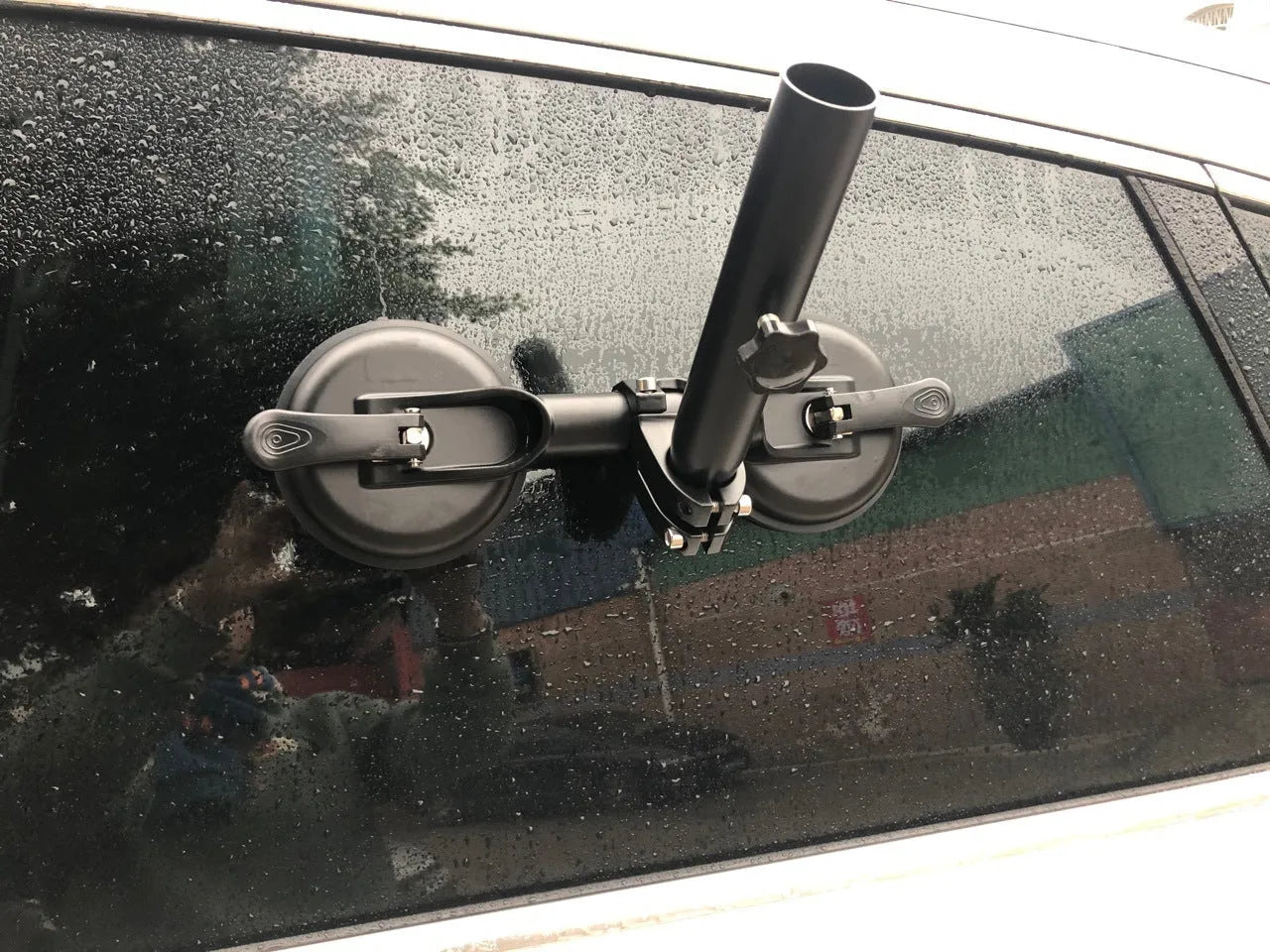 Black off-road car windscreen sucker mount with a large round rubber suction cup for flagpoles.