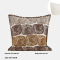 Cream and coffee coloured abstract coil pattern square pillow cover on a grey sofa.