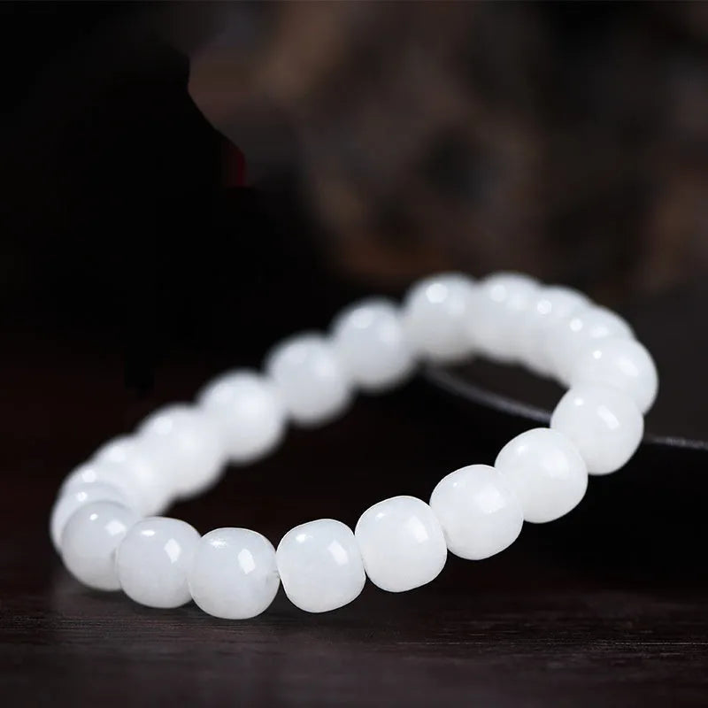 White Hetian jade barrel bead bracelet for men and women, shown in a casual style.