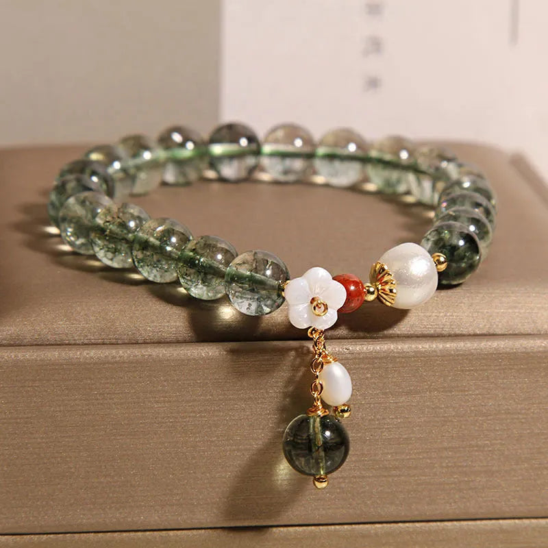 Green phantom quartz crystal bracelet with Bells of Ireland and shell flower design