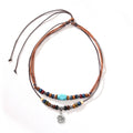 Men's retro necklace with geometric flower pendant and turquoise wooden beads on a wax rope chain.