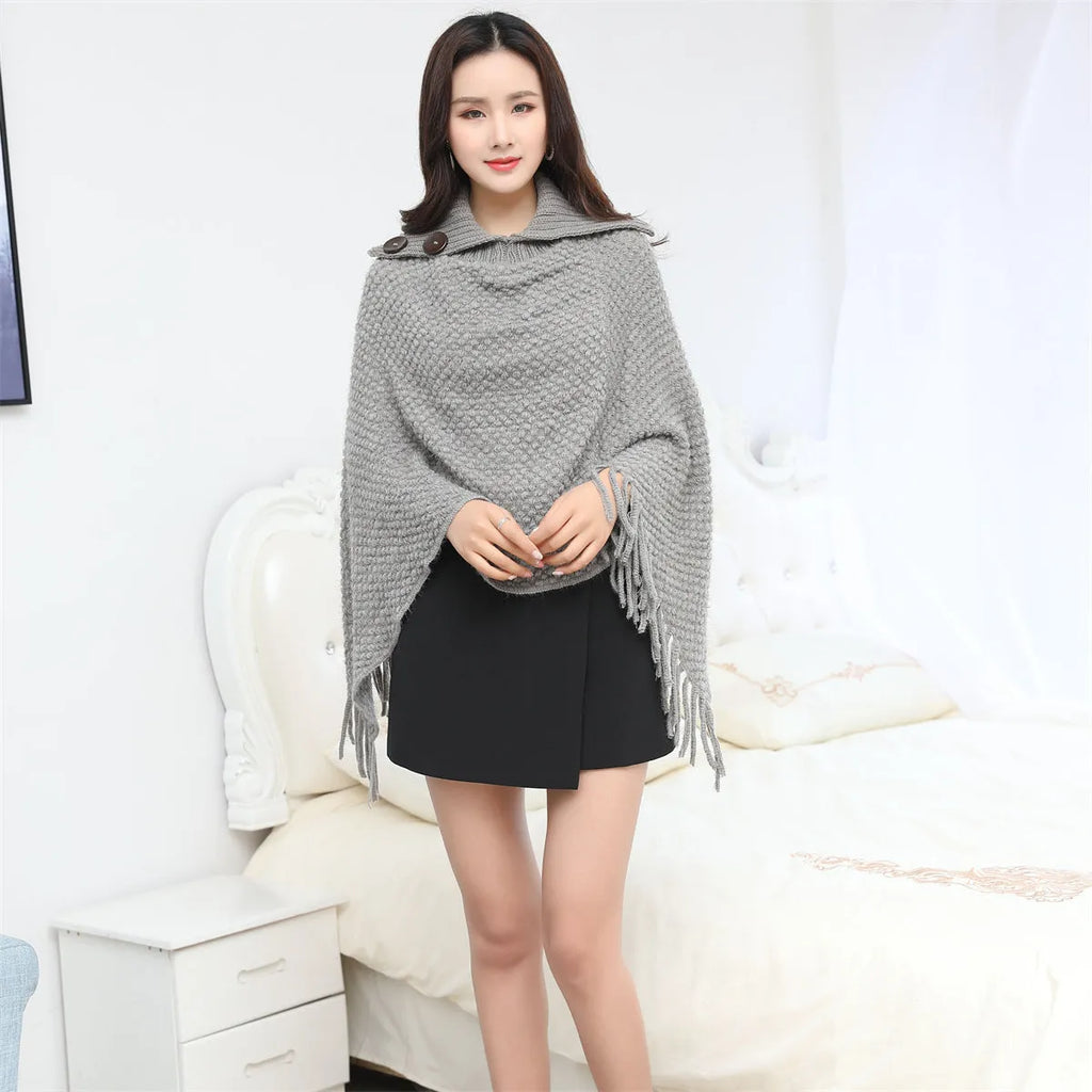 Dotted pattern sleeveless knitted cloak shawl in acrylic fibre, shown in apricot colour.