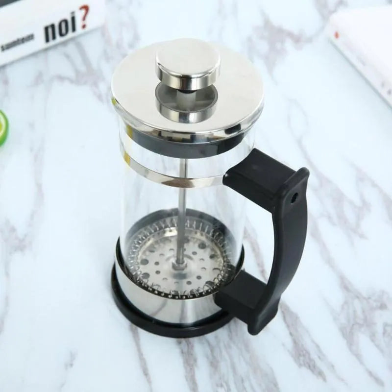 Manual pour-over coffee brewer with glass carafe and stainless steel filter, 350ml capacity.