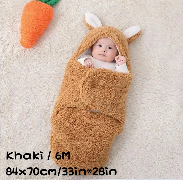 A baby wearing a soft grey fleece sleeping bag with hook-and-loop shoulder straps.