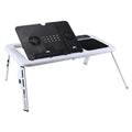 White folding computer desk bed with adjustable legs and tilting baseplate, open on a bed showing dual heat vents